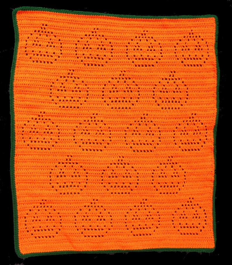 May include: An orange crochet blanket featuring a repeating pattern of jack-o'-lantern faces. The blanket has a green border. The jack-o'-lanterns are created with open spaces in the crochet work. This handmade blanket is perfect for Halloween.