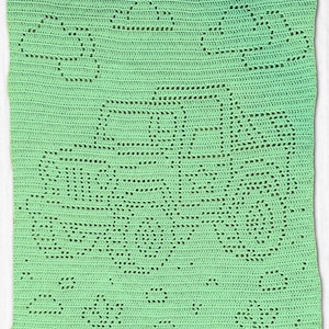 May include: A light green crocheted blanket with a floral design. The blanket features a repeating pattern of flowers and geometric shapes, creating a textured surface. The crochet work is detailed and the color is a soft, pastel green.
