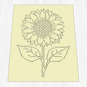 Puede incluir: Una manta rectangular de ganchillo color crema con un dise&ntilde;o gr&aacute;fico negro centrado de un gran girasol que presenta una cabeza circular detallada, un tallo central y dos hojas sim&eacute;tricas que se extienden desde la base.