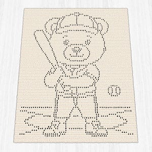 May include: A rectangular cream-colored crochet blanket featuring a black graphic pattern of a teddy bear wearing a baseball cap. The bear is depicted holding a baseball bat, with a small baseball nearby and the word PLAY written below.