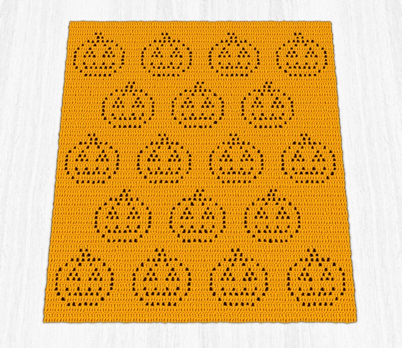 May include: An orange crocheted blanket featuring a repeating pattern of jack-o'-lantern faces. The pumpkins are outlined in black, with triangular eyes and noses, and a smiling mouth. The blanket is a square shape.