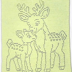 May include: A rectangular crochet blanket in a pale yellow colour featuring a dark green outline pattern of a deer standing next to a fawn. The design is created using a filet crochet technique, showing the silhouettes of the two animals.