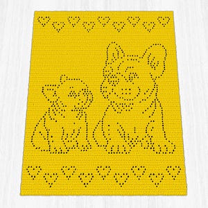 May include: A bright yellow rectangular crochet blanket featuring a dark brown pattern of two dogs, one smaller and one larger, positioned side by side. The design includes a horizontal row of small heart shapes along the top and bottom edges.