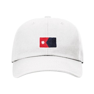 May include: A white baseball cap with a red, white, and blue embroidered flag on the front.