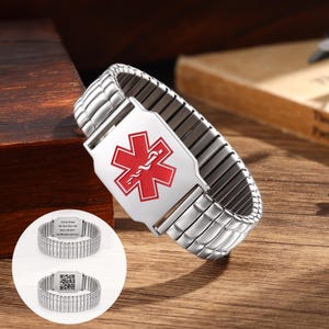 May include: A silver-toned medical alert bracelet featuring an expandable metal link band and a central rectangular plate displaying a red Star of Life symbol. The inset shows the back of the bracelet with engraved text and a square QR code.