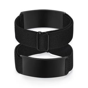May include: Two black elastic shirt stays with rectangular metal plates. The stays are designed to keep shirts tucked in and are made of a woven fabric. The metal plates are a solid black color.