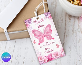 May include: A pink butterfly-themed gift tag with the words "Thank You" and "For Fluttering By!" in a decorative font. The tag is adorned with floral and butterfly illustrations, and the name "Isabella" is written at the bottom.