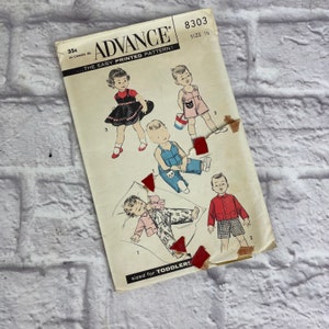 May include: Vintage sewing pattern for toddlers, featuring four different outfits. The pattern is from Advance, the easy printed pattern, and is size 1 1/2. The outfits include a dress, overalls, a shirt and pants, and a shirt and shorts.