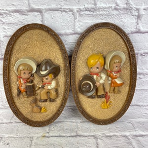 Pair of Vintage 1980’s Era Burwood Home Interiors Hubbell Raised Plastic Cowboy & Pioneer Girl Oval Wall Hangings