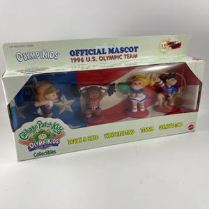 May include: A boxed set of Cabbage Patch Kids OlympiKids collectibles. The set includes four figurines representing track & field, weightlifting, tennis, and gymnastics. The box features the text "Official Mascot 1996 U.S. Olympic Team."