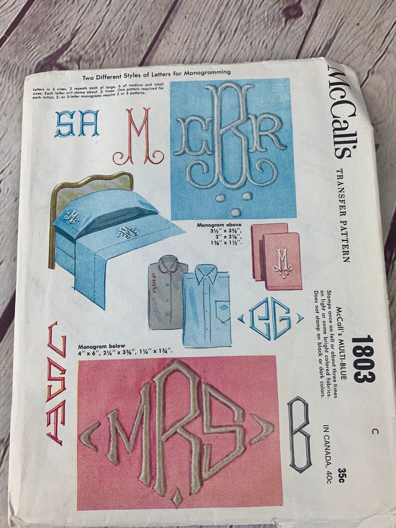 May include: McCall's Transfer Pattern 1803 Multi-Blue. This pattern includes two different styles of letters for monogramming, with sizes ranging from 3.2 cm to 10 cm. The pattern is printed on a white background with blue and red accents.
