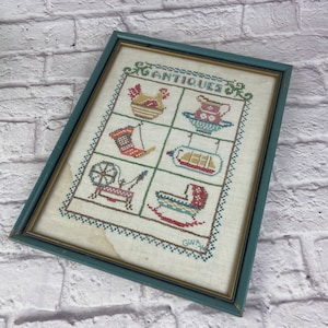 Vintage Painted Wood Framed Hand Embroidery Cross Stitch Sampler Antiques Rocking Bassinet, Pitcher & Bowl, Hen On Nest, Ship In A Bottle
