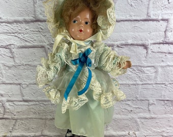 Vintage Creepy Composition Doll with Blue Painted Eyes and Wild Hair