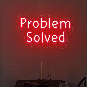 May include: A neon sign with the words "Problem Solved" in white lettering with a pink glow. The sign has a dripping effect, making it look like the letters are melting.