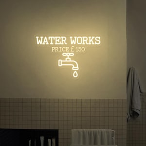 May include: A white neon sign with the text "WATER WORKS" and "PRICE £ 150" with a stylized image of a tap with a water drop below it.