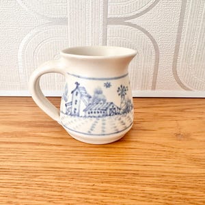 Vintage blue and white hand painted pottery cup mug