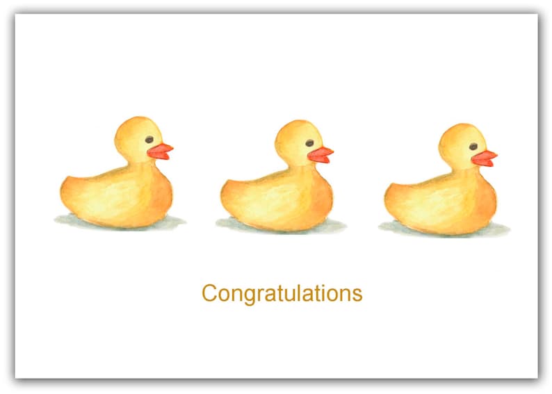 May include: Three yellow rubber duck toys with orange beaks and black eyes, lined up in a row on a white background. The text "Congratulations" is written in gold below the ducks.