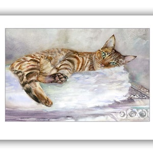 May include: A watercolor painting of a brown tabby cat with green eyes lying on a white fluffy pillow. The cat is looking directly at the viewer with a relaxed expression.