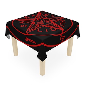May include: Black tablecloth with a red pentagram and the words "Samael Lilith" in a circle around it.