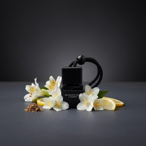 Könnte beinhalten: Eine kleine, quadratische schwarze Glasflasche mit schwarzem Verschluss und schwarzer Aufhängeschnur. Das Etikett trägt die Aufschrift BLOSSOM WATER + JASMINE. Die Flasche ist umgeben von weißen Jasminblüten, grünen Blättern, Zitronenscheiben.