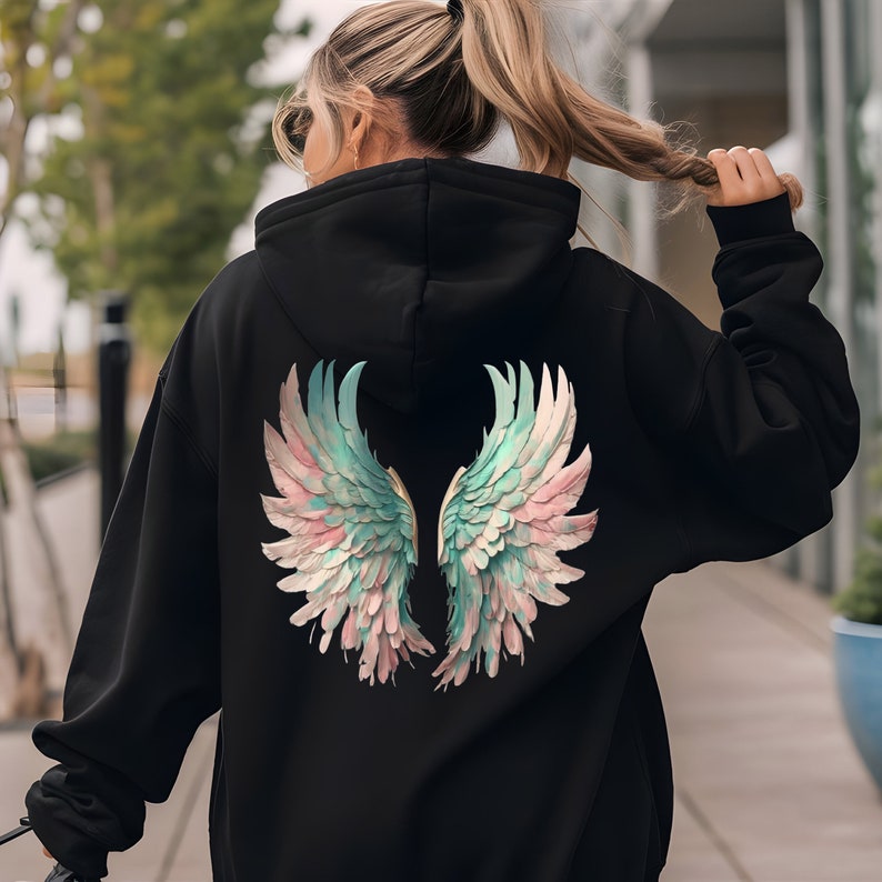 May include: Black hoodie with a large, colorful angel wing design on the back. The wings are painted in shades of pink, blue, and white.