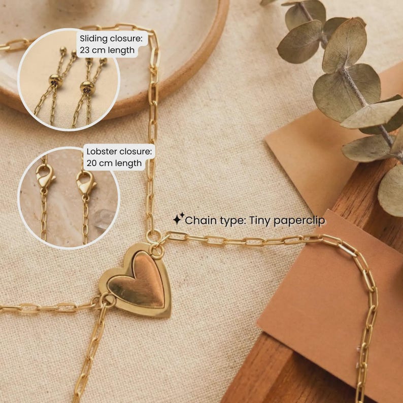 May include: Gold-colored necklace with a heart pendant. The chain type is a tiny paperclip design. The necklace features a sliding closure with a 23 cm length and a lobster closure with a 20 cm length.