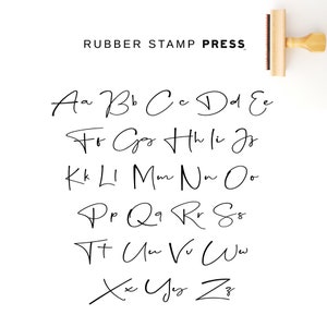 May include: A black and white image of a handwritten alphabet in a cursive font. The letters are arranged in rows, with each row starting with a different letter. The text "RUBBER STAMP PRESS" is at the top of the image.