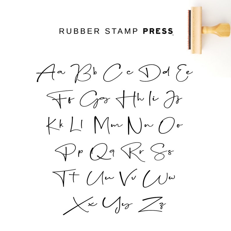 May include: A black and white image of a handwritten alphabet in a cursive font. The letters are arranged in rows, with each row starting with a different letter. The text "RUBBER STAMP PRESS" is at the top of the image.