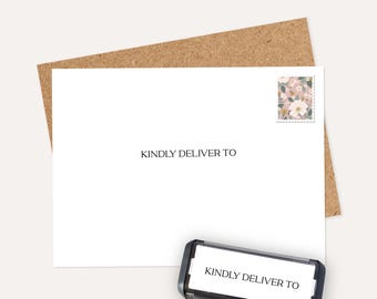 May include: A white envelope with the text "KINDLY DELIVER TO" printed on it, along with a floral stamp. A black stamp with the same text is at the bottom, ready to be used. The envelope is on a brown background.