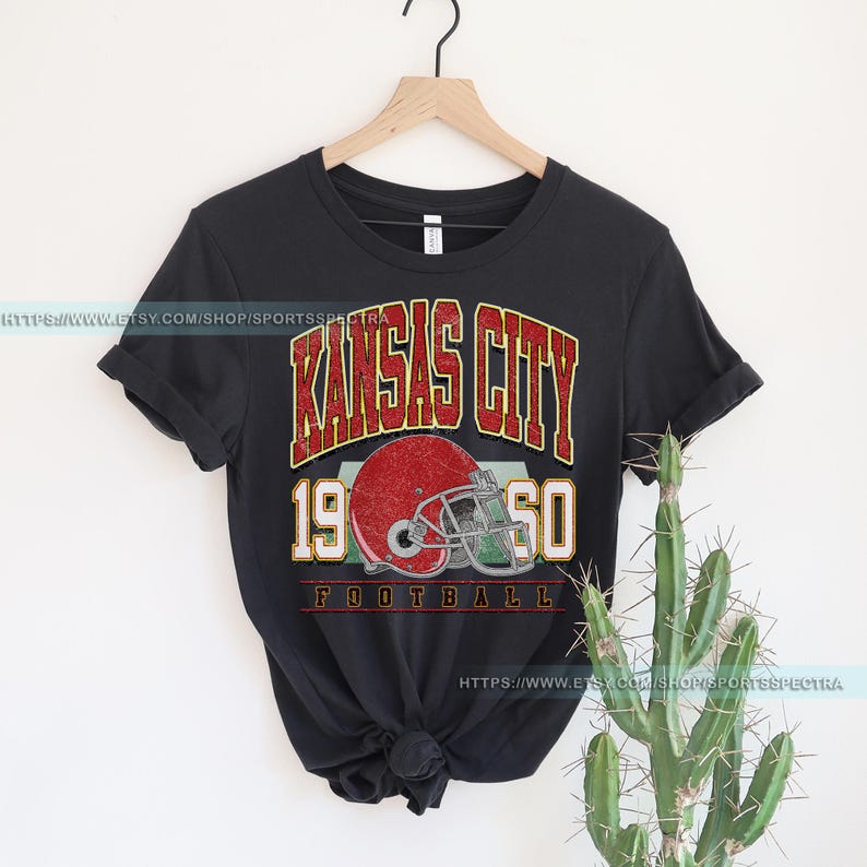 May include: Black t-shirt with a vintage-style graphic of a football helmet and the text "Kansas City 1950 Football".