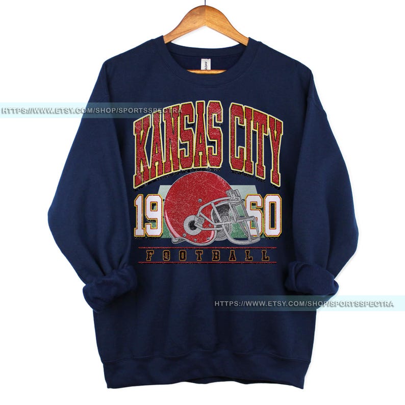 May include: Navy blue sweatshirt with a vintage-style graphic of a football helmet and the text "Kansas City 1950 Football".