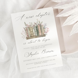 May include: A white invitation card with the text "A new chapter is about to begin" in elegant script. The card features a watercolour illustration of books and flowers. The invitation is for Sophie Brown's event.
