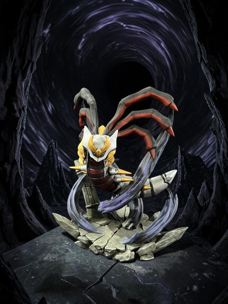 May include: A detailed figurine of a creature with a white, yellow, and red color scheme, set against a dark, cavernous background. The figure has multiple arms and a dynamic pose, standing on a cracked stone base.