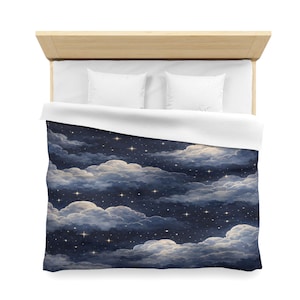 May include: A duvet cover featuring a night sky design with fluffy white and gray clouds against a dark blue background. The design includes numerous small, sparkling stars, creating a dreamy, celestial theme. The bedding is on a wooden bed frame.
