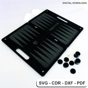 May include: Black backgammon board with a grey patterned playing surface and the text "PENC-U-SE". The board is closed and has a handle on each side. There are black playing pieces and white dice on a white surface.