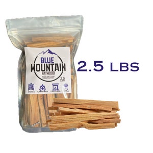 May include: A clear plastic bag filled with 2.5 pounds of natural fatwood fire starters. The bag has a blue and white label that says "Blue Mountain Fatwood 100% Natural Firestarters". The label also shows icons for stoves, campfires, fireplaces, and grills.
