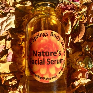 May include: A glass bottle of amber-colored facial serum with a dropper. The label is orange and says "Green Springs Body Works" and "Nature's Facial Serum". The website address "greensprings0.etsy.com" and a phone number are also on the label.