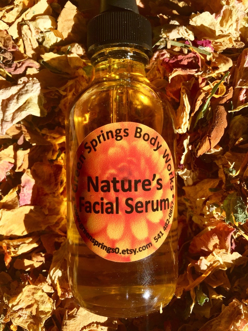May include: A glass bottle of amber-colored facial serum with a dropper. The label is orange and says "Green Springs Body Works" and "Nature's Facial Serum". The website address "greensprings0.etsy.com" and a phone number are also on the label.