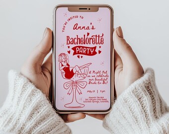 May include: A smartphone displays a pink bachelorette party invitation. The invitation features red text and illustrations, including a woman in a cocktail glass. The text reads "Anna's Bachelorette Party" and includes event details.