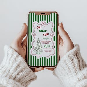 May include: A smartphone displays a Christmas dinner invitation. The invitation features a green and white striped background with a decorative frame. Text includes "OH WHAT FUN!" and "CHRISTMAS DINNER" with a Christmas tree illustration.