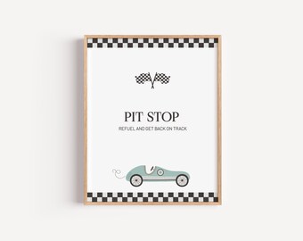 May include: Framed print with a racing theme. The artwork features a light blue vintage race car, checkered flags, and the words "PIT STOP" with the tagline "REFUEL AND GET BACK ON TRACK". The frame has a black and white checkered border.