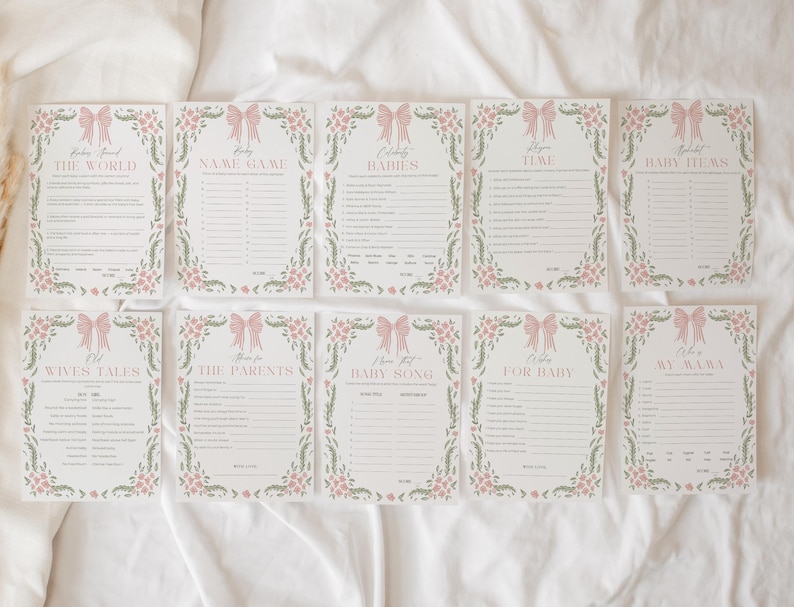 May include: A set of ten baby shower game cards. Each card features a pink bow and floral border. The titles include "The World", "Name Game", "Babies", "Time", "Baby Items", "Wives Tales", "The Parents", "Baby Song", "For Baby", and "My Mama".