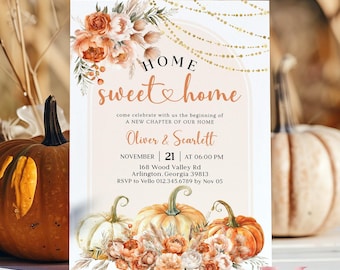 May include: A fall-themed housewarming invitation with a watercolor illustration of pumpkins, flowers, and a golden garland. The text reads "HOME sweet home" and includes the names "Oliver & Scarlett", the date "November 21", the time "06:00 PM", the address "168 Wood Valley Rd. Arlington, Georgia 39813", and the RSVP information.