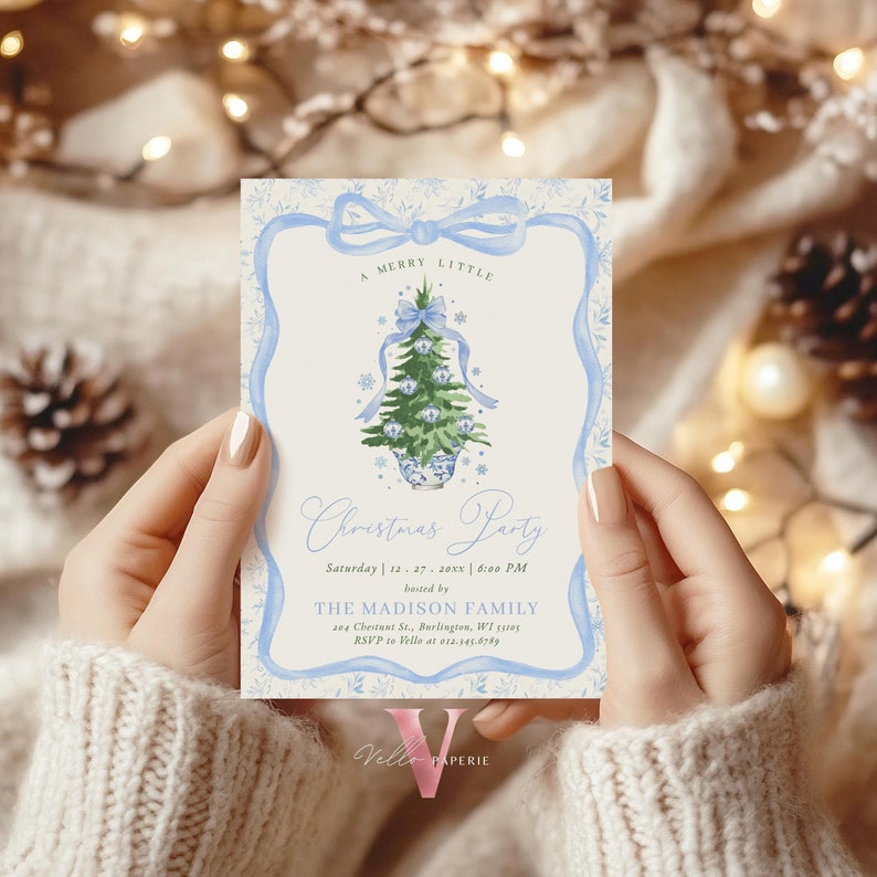 May include: A light blue and cream Christmas party invitation with a watercolour Christmas tree design. The invitation includes the text "A MERRY LITTLE Christmas Party" and event details. The invitation is held by a person.