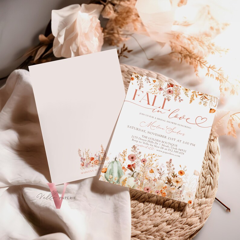 May include: Fall in love bridal shower invitation with a watercolor floral design featuring pumpkins, leaves, and flowers in shades of orange, pink, and green. The text reads "Fall in love" with a heart and "Join us for a bridal shower honoring Madeline Santos".