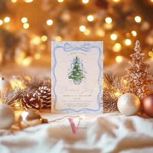 May include: A festive Christmas party invitation featuring a light blue border and a watercolour Christmas tree design. The invitation includes the text "A Merry Little Christmas Party" and event details. The Vella Paperie logo is at the bottom.