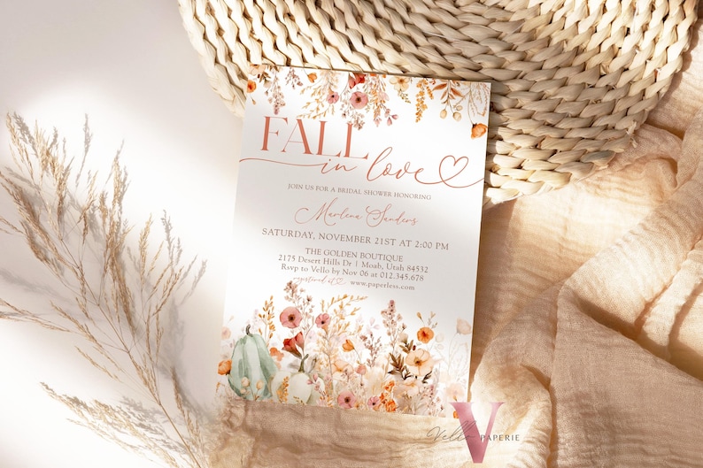 May include: Fall in love bridal shower invitation with a watercolor floral design featuring pumpkins, leaves, and flowers in shades of orange, pink, and green. The invitation text reads "Fall in love" with a heart and "Join us for a bridal shower honoring Marlene Senders".