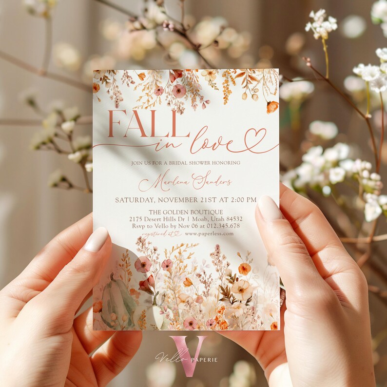 May include: Fall in love bridal shower invitation with a watercolor floral design in shades of orange, pink, and green. The invitation features the text "Fall in love" with a heart and the date "Saturday, November 21st at 2:00 PM".