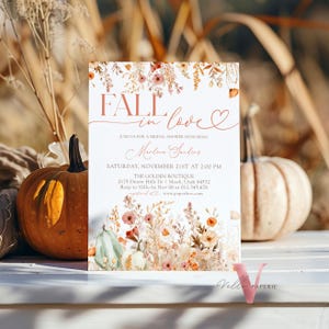 May include: Fall in love bridal shower invitation with a watercolor floral design in shades of orange, pink, and green. The invitation features the text "Fall in love" in a script font with a heart symbol. The text also includes the date, time, and location of the shower.