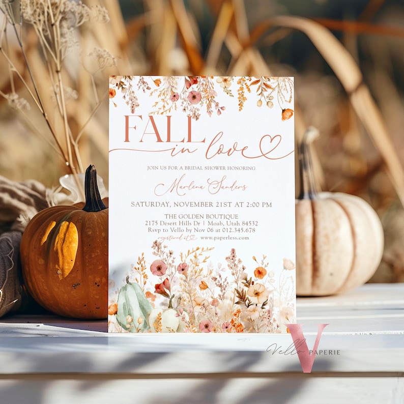 May include: Fall in love bridal shower invitation with a watercolor floral design in shades of orange, pink, and green. The invitation features the text "Fall in love" in a script font with a heart symbol. The text also includes the date, time, and location of the shower.